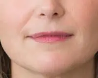 A woman with pink lips and a white nose.