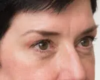 A close up of a person 's eyes with brown eye makeup.