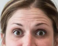 A woman with brown eyes looking up at the camera.