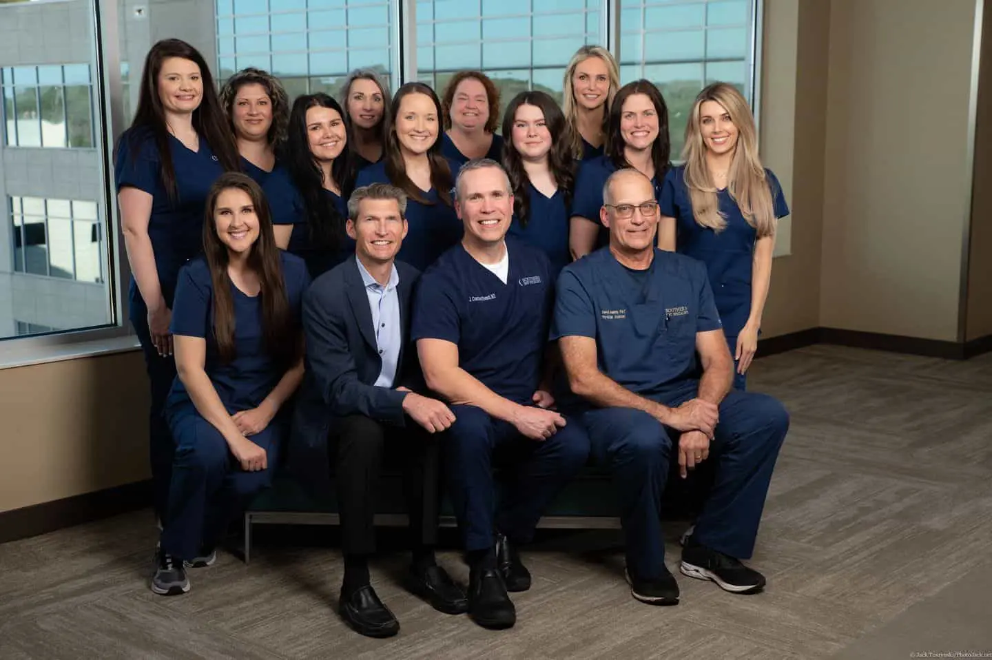 A group of doctors and nurses posing for a picture.